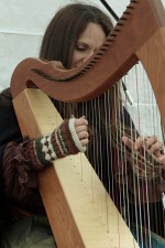 Harpist playing at a festival Harpist playing at a festival.